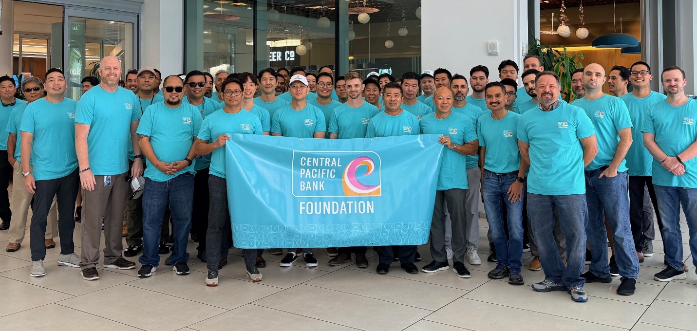 Men participating on behalf of Central Pacific Bank Foundation in the Men's March Against Violence pose with the Foundation banner.
